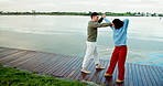 Couple, dancing and smile by lake, vacation and rhythm with connection, trust and love in nature. Man, woman and partner with holding hands, conversation and happy with romance at park in Colombia
