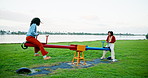 Field, playground and seesaw with woman friends outdoor in park for bonding, fun or vacation. Balance, energy and playing with happy people at lake in nature together for travel or winter holiday