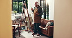 Elderly man, artist or dancing with headphones on canvas in home for art, hobby or fun activity. Senior, male person or painter with expression on easel for artistic creation or artwork in retirement
