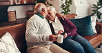 Coffee, phone and elderly couple kiss for love, conversation and laugh together with embrace in home. Tea, man and woman in retirement with mobile for romance, funny joke and connection for marriage