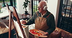 Headphones, senior man and painting for art in home, inspiration song and dancing for talent. Elderly person, music and artist with brush for retirement hobby, creative drawing and listening to audio