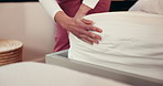 Hands, housekeeping and making bed with person in hotel room for hospitality or routine maintenance. Change, chores and cleaning with housekeeper in bedroom of resort for daily turndown service