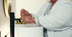 Senior woman, hygiene and washing hands in bathroom sink for cleanse, bacteria or germ removal. Closeup, elderly or female person with water, tap or faucet for handwash, disinfect or protection