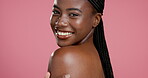 Skincare, shoulder and happy with face of black woman in studio for body care, dermatology and glow. Beauty, shine and hydration with person on pink background for collagen, treatment and cosmetics