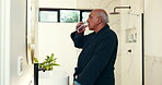 Drinking water, pills and healthcare with old man in bathroom for morning vitamins, supplements and patient. Arthritis medication, prescription drugs and medical tablet with elderly person in home