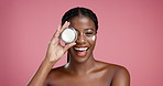 Face, black woman and cream product for skincare, glow or sunscreen treatment for dermatology. Portrait, happy person and show jar for cosmetics, beauty or facial hydration on pink studio background