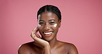Face, black woman and smile with lotion for skincare for beauty, facial hydration and studio. Female person, spf and cream with moisturising benefits, treatment glow and self care on pink background
