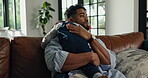 Comfort, console or hug with father and son on sofa in living room of home for safety or security. Bonding, love or trust with boy child and single parent man embracing in apartment for empathy
