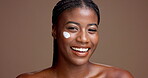 Face, woman and cream for skincare, laughing or facial treatment for glow of skin, happy and beauty. Studio background, moisturizer or cosmetic for black person, mockup space and shine with lotion