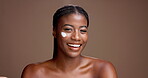 Face, woman and cream for skincare, happy or facial treatment for glow of skin, laughing and beauty. Studio background, moisturizer or cosmetic for black person, mockup space and shine with lotion