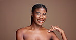 Chest, beauty and smile with face of black woman in studio for skincare, body care and hygiene. Glow, dermatology and shine with female model on brown background for mockup space and grooming