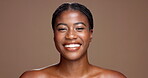 Skincare, beauty and smile with face of black woman in studio for aesthetic, self care and hygiene. Glow, dermatology and shine with female model on brown background for mockup space and grooming