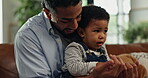 Bonding, game or holding hands with father and son on sofa in living room of home together. Development, love or security with boy child and single parent man in apartment for playful activity