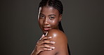 Black woman, face and glow with skincare in studio, touch shoulder or smile for results by background. African girl, happy and natural beauty with portrait, confidence and mock up space in Nigeria