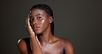 Beauty, skincare and hands with face of black woman in studio for glow, dermatology and self care. Mockup space, hydration and aesthetic with female model on dark background for shine and grooming