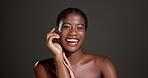 Laugh, skincare and hands with face of black woman in studio for glow, dermatology and self care. Mockup space, hydration and aesthetic with female model on dark background for comic and beauty