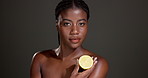 Woman, face and lemon in studio with beauty, results or organic diet for healthy skin by background. African girl, model and citrus fruit for nutrition, mockup space and vitamin c benefits in Nigeria