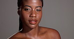 Face, beauty glow or African model with makeup in studio for confidence or healthy skin. Dermatology cosmetics, proud or black woman isolated on gray background with shine, mockup space and wellness