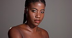 Face, beauty glow or black woman with makeup in studio for confidence or healthy skin. Dermatology cosmetics, proud or African person isolated on gray background with shine, mockup space and wellness