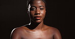 Face, dermatology and woman with glow, studio or bodycare with cosmetics, healthy skin or confident. Gray background, black person and pride for shine, shadow or self care with treatment and wellness