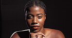 Face, beauty glow and African woman on black background with makeup, confidence and healthy skin. Dermatology cosmetics, facial or proud female person in studio with shine, mockup space and wellness
