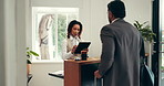 Front desk, tablet and hotel concierge with man for accommodation, booking help and business trip. Conversation, tech and receptionist with guest for hospitality, service or corporate travel check in