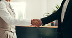 Hotel reception, hands and people with handshake for welcome, concierge service and hospitality. Front desk, receptionist and greeting client in lobby for introduction, accommodation or check in help