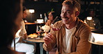 Man, happy and drinking wine at restaurant for date, friendly conversation or people out at night. Couple, alcohol and anniversary milestone in events venue with communication, bonding or funny story