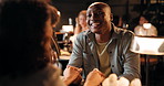 Talk, happy couple and holding hands in restaurant for date, love and connection together. Man, woman and romance at dinner for relationship, laugh or commitment for anniversary with support at night