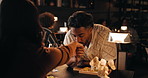 Love, couple and kiss hand in restaurant for trust, date and connection together on anniversary. Happy man, woman and romance at dinner for relationship, commitment and loyalty with partner at night