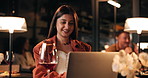 Happy, laptop and remote work with woman in restaurant at night for online planning or research. Computer, typing and wine with smile of freelance business employee at fine dining eatery for startup