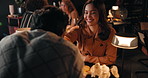 Date, couple and kiss hand in restaurant for trust, love and connection together on anniversary. Happy man, woman and romance at dinner for relationship, commitment and flirt with partner at night