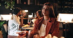 Woman, talking and night with date in restaurant for conversation, romantic dinner or occasion. Female person, romance and speaking in late evening with wine or drink for fine dining or chat in cafe