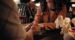Love, couple and holding hands in restaurant for date, trust and connection together. Man, woman and romance at dinner for relationship, care and commitment for anniversary with loyalty at night