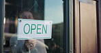 Door, small business or man with open sign in coffee shop or restaurant for service or advertising. Storefront, window or entrepreneur in cafe with board, poster or welcome for text or hospitality