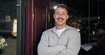 Happy, crossed arms and face of barista at restaurant with confidence for hospitality industry. Smile, pride and portrait of male waiter from Canada at door for welcome in customer service at diner.