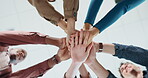 Low angle, hand stack and business people in office for teamwork, collaboration and support. Community, startup company and workers in circle for solidarity, cooperation and partnership synergy