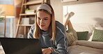 Woman, student and relax on laptop at house for research, online learning and scholarship application. Smile, female person and typing on pc for assignment, studying and email feedback for education