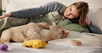 Puppies, dog mom and playing on bed in home bedroom for fun, development or bonding. Pets, adoption and house with golden retriever animals and person for love, care and laugh for funny behaviour