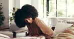 African woman, stomach pain and sofa at house with menstruation, ibs and constipation. Sick, female person and  tummy cramps with belly bloating, abdominal problem and endometriosis crisis in lounge