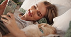 Relax, pet and woman with phone in bedroom, texting and chilling with puppy in home, online and web. Calm, person and resting with dog on bed, browsing and bonding with canine in house or mobile app
