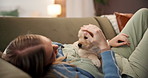 Woman, relax and couch with dog in lounge for companion, connection and bonding together. Female person, stroke and rescue puppy for love, animal affection and labrador adoption for pet care at house