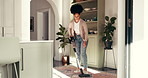Home, cleaning and black woman with vacuum for dust, hygiene and floor maintenance for health. Apartment, sanitation and person with electric machine for housekeeping, housework and dirt prevention
