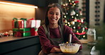 Christmas, baking and face of child in kitchen with bowl for cookies, dessert and cake recipe. Happy baker, home and portrait of girl with ingredients for holiday, festive tradition and xmas treats