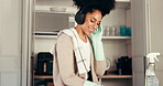 Cleaning, woman and listen to headphones, disinfection and chores with chemical in home and kitchen. Happy, person and glove for protection in house, music and streaming on app, hygiene or dancing