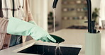 Washing, dishes and person with gloves in kitchen, hygiene or cleaning with chores in home and sink. Morning, routine and hands with chemical for bacteria prevention, disinfection and housework