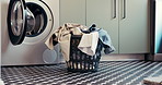 Laundry, washing machine and basket with clothes in home for maintenance, housework or hygiene. Empty, apartment and container with textiles, fabric and material for housekeeping, cleaning or chores