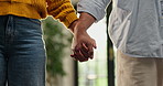 Love, support and couple holding hands together for solidarity, kindness and trust in home living room. Closeup, man and woman in apartment lounge for care, unity and romance for holiday or vacation
