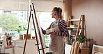 Canvas, learning and painting with woman in studio apartment for artistic or creative expression. Easel, inspiration and process with painter in home for art project, drawing activity or hobby