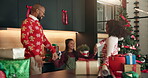 Dance, Christmas and gift with family in kitchen for holiday season, celebration and bonding. Present, festive tradition and package with parents and child in home for decoration, energy and music
